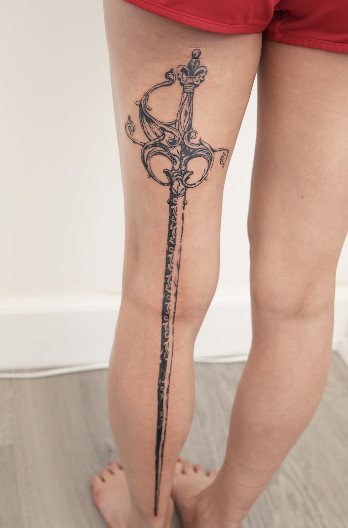 sword blackwork style tattoo by Tina Choi