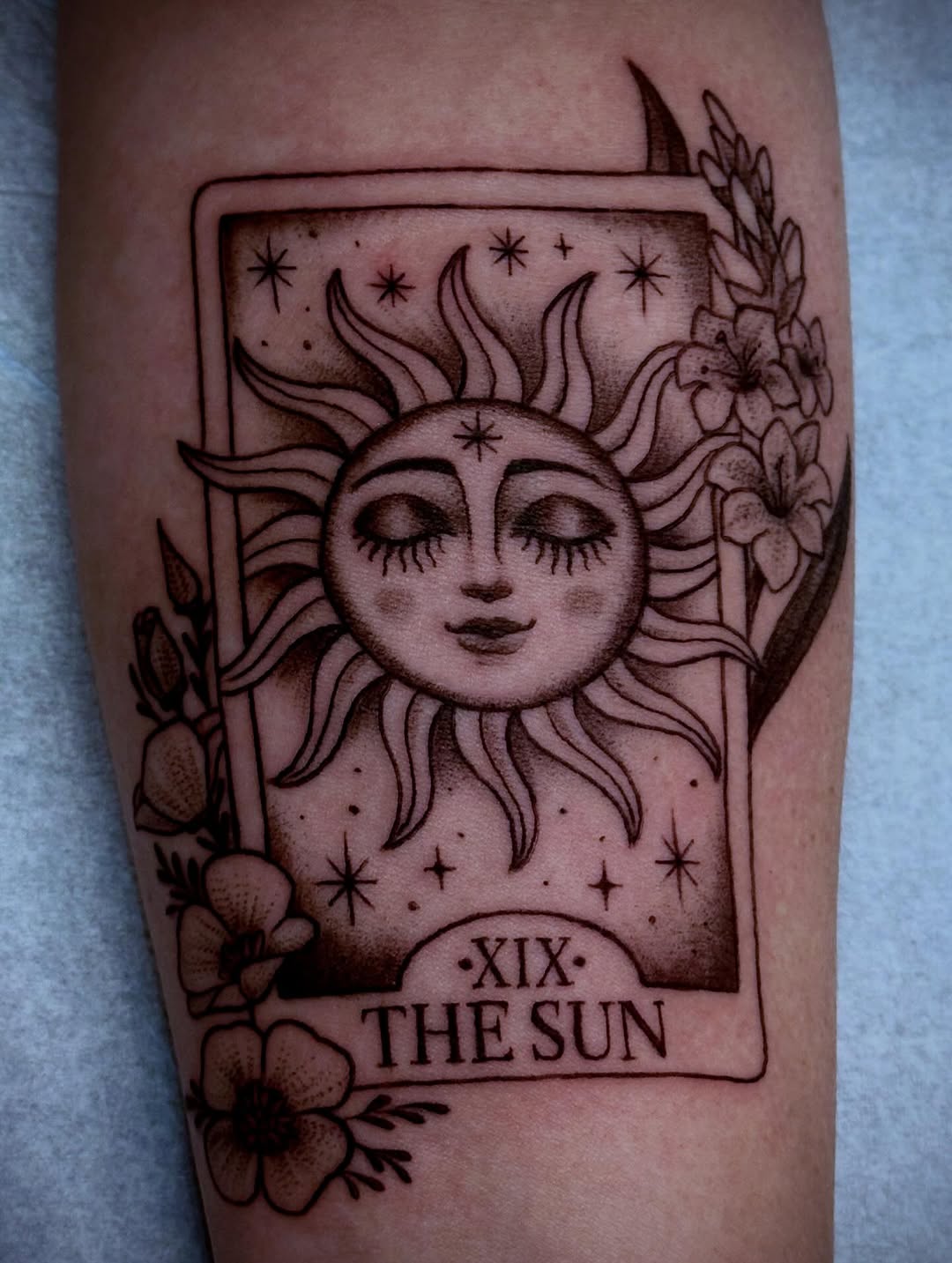 tarot card and flower blackwork style tattoo by Melissa Taylor