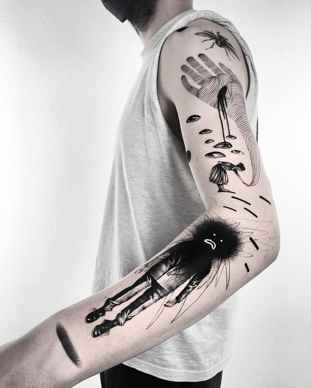 person and insect blackwork style tattoo by Matteo Nangeroni